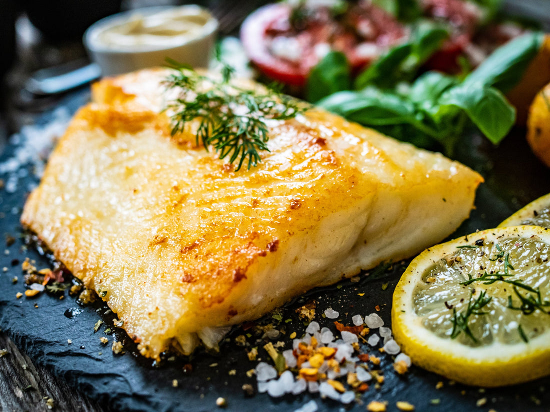 Seared wild Alaskan halibut portion with lemon