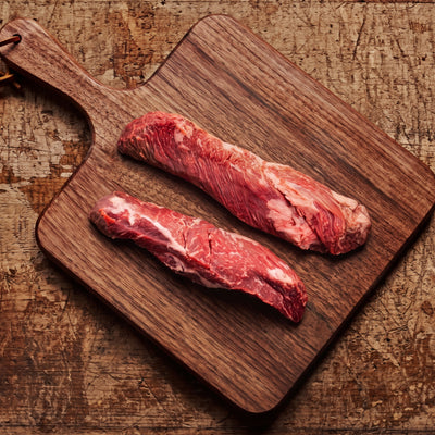 Hanger steak on a walnut board, top down