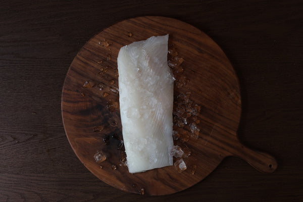 Wild Alaskan halibut fletch on a cutting board